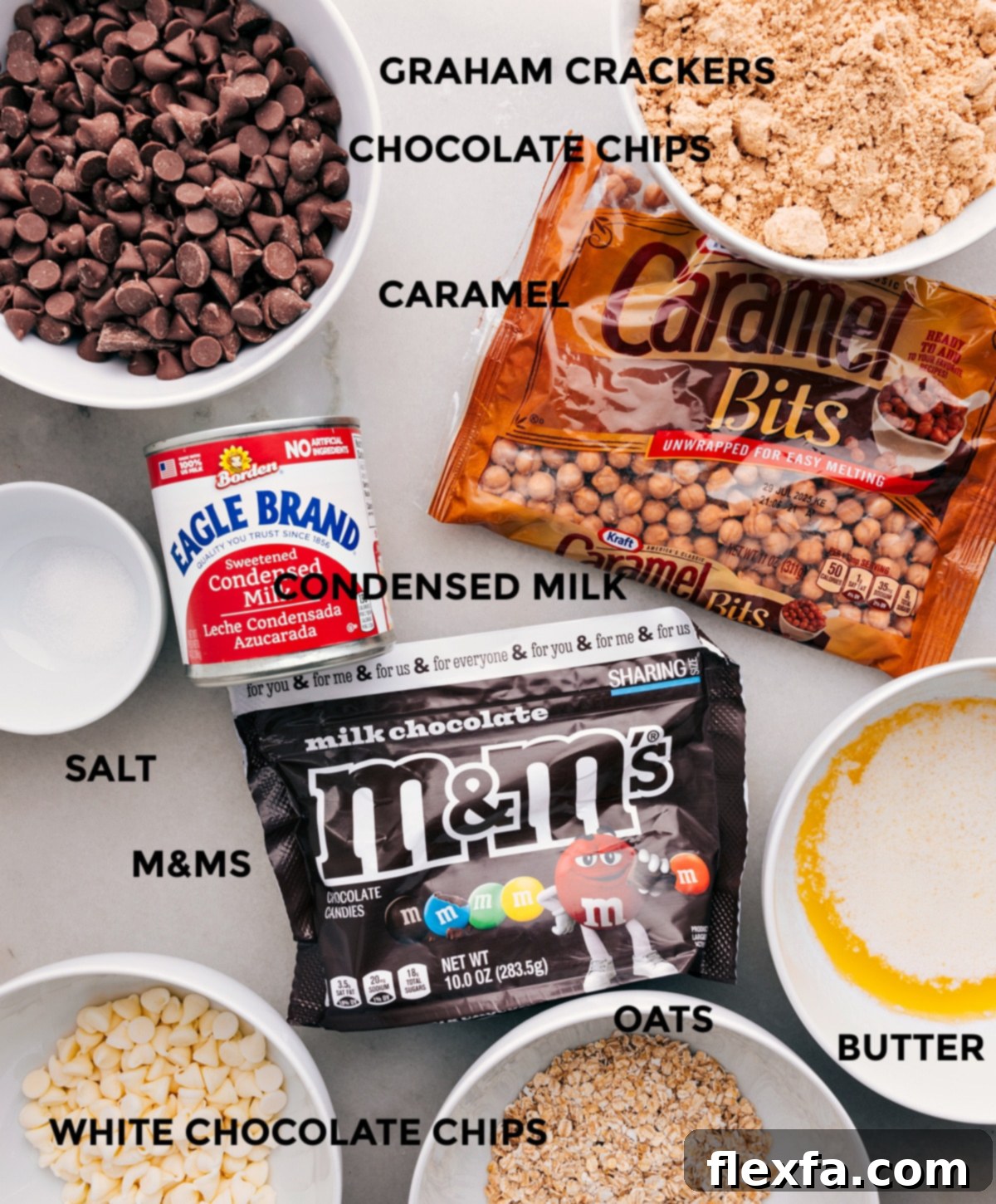 Key Ingredients For Perfect Magic Cookie Bars All the essential ingredients for Magic Cookie Bars laid out: graham crackers, caramel bits, condensed milk, chocolate chips, M&M's, butter, quick oats, and a pinch of salt.