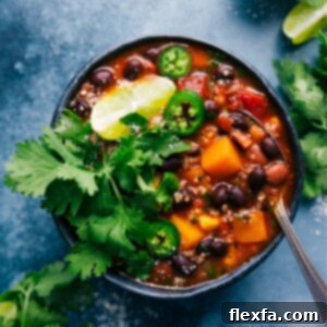A tantalizing close-up of a bowl of Butternut Squash Chili, rich in color and texture, ready to be enjoyed.