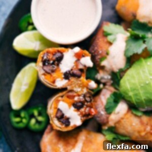 Crispy Air Fryer Sweet Potato and Black Bean Egg Rolls 2 A plate of golden crispy Air Fryer Sweet Potato and Black Bean Egg Rolls with chili-lime dipping sauce.