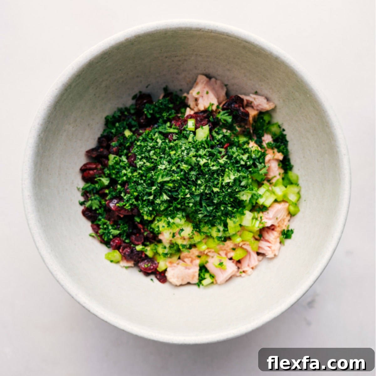 All the prepared ingredients for this quick and easy tuna salad are gathered in a large mixing bowl, poised for a gentle toss to combine into a delicious, creamy low-carb lunch.
