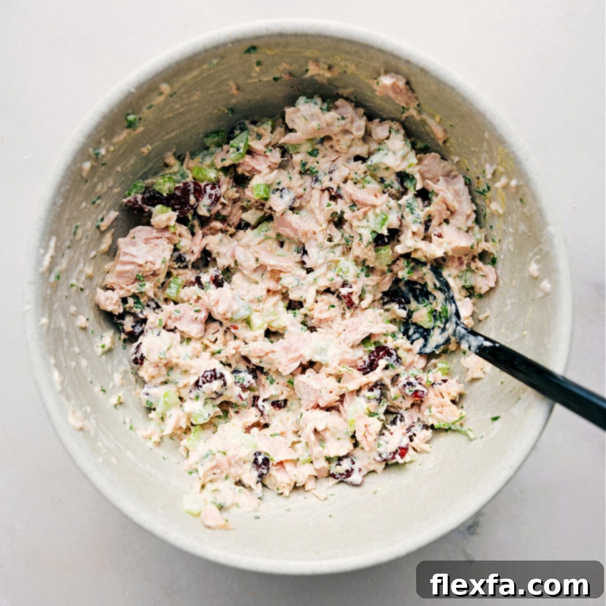 A close-up shot of the creamy and fresh tuna salad served elegantly in a bowl, highlighted as a perfect, quick, and healthy low-carb lunch idea. The textures and colors are inviting.