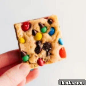 M&M Cookie Bars being held up.