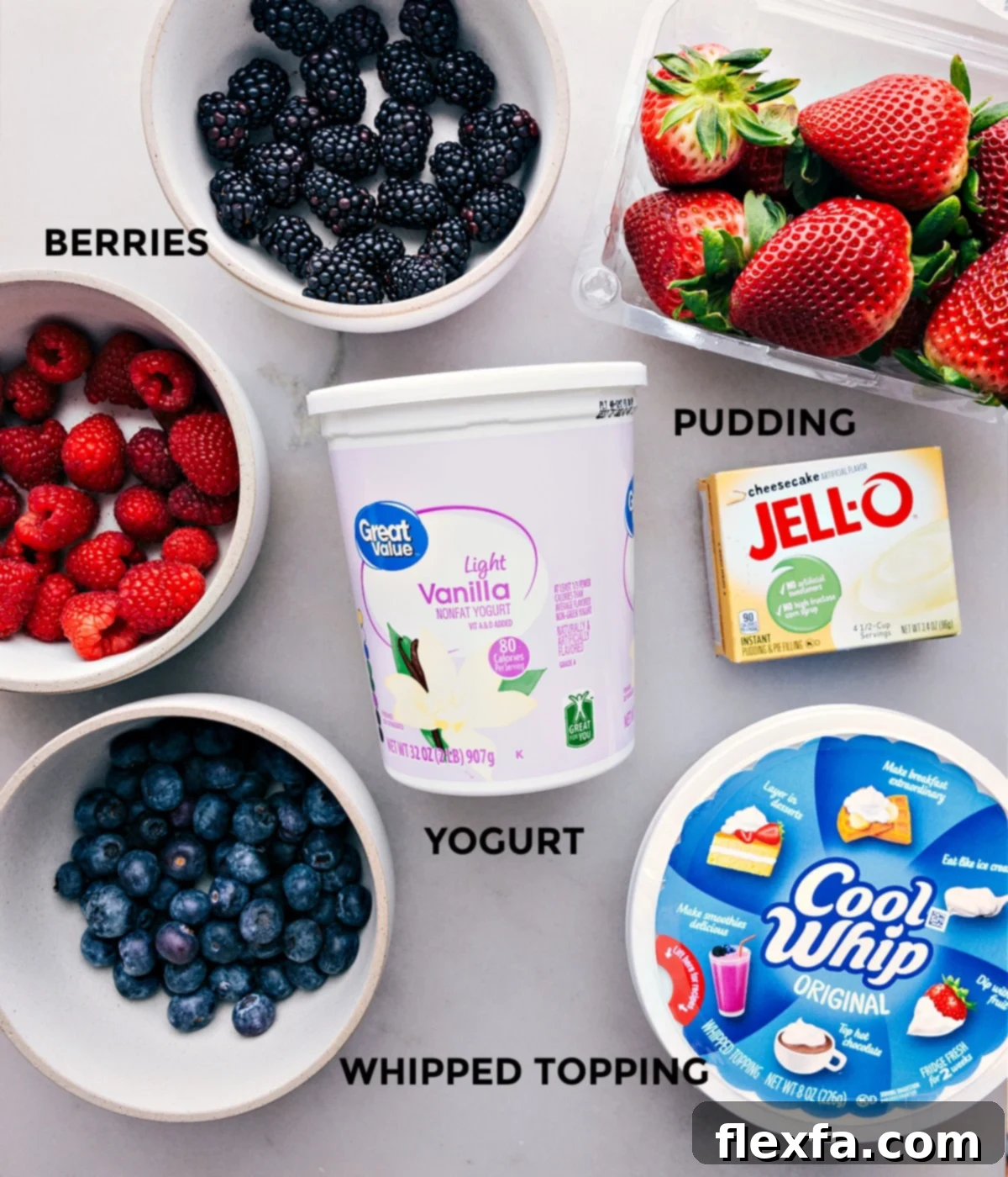 Ingredients for Cheesecake Fruit Salad, including berries, vanilla, jell-o, and cool whip.