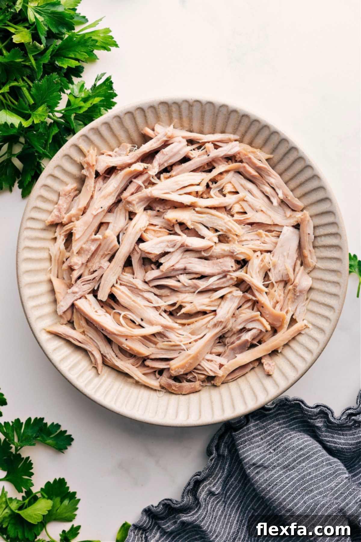 Bowl of perfectly shredded chicken ready to be used in various recipes