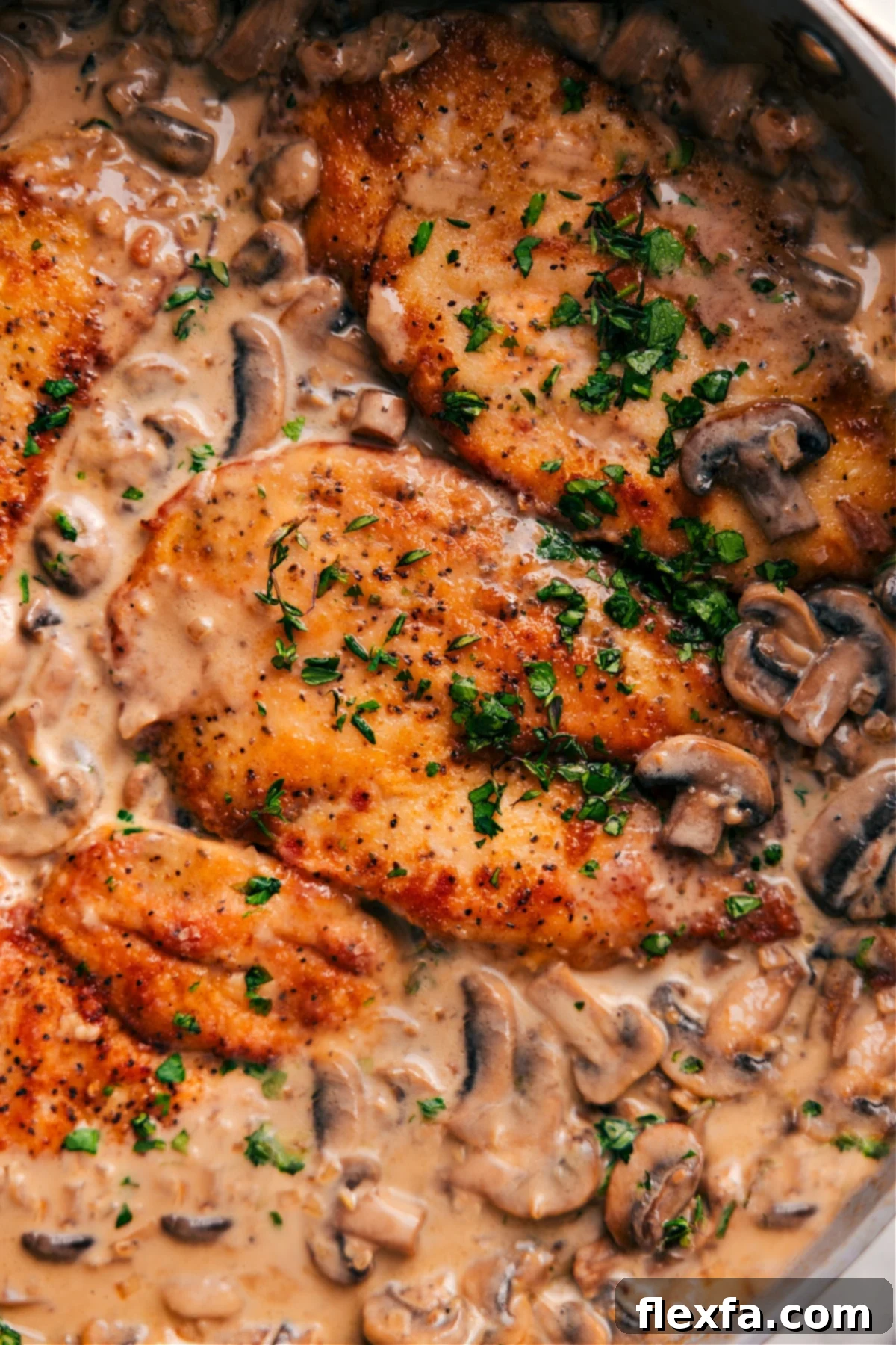 Chicken Marsala simmering in a pot, garnished with fresh parsley.