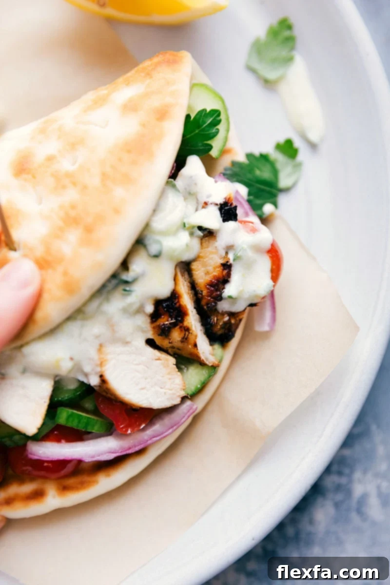 Delicious Chicken Gyro Ready to Eat A mouthwatering chicken gyro wrapped in pita bread, packed with seasoned chicken, vibrant vegetables, and creamy tzatziki sauce.
