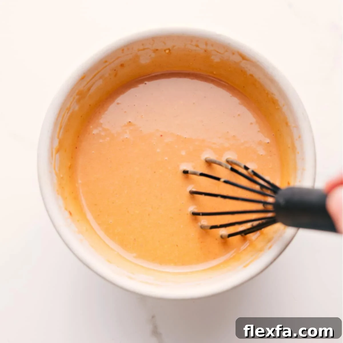 Soba Noodle Salad Dressing: The ingredients are whisked together in a bowl, creating a smooth and creamy sauce.