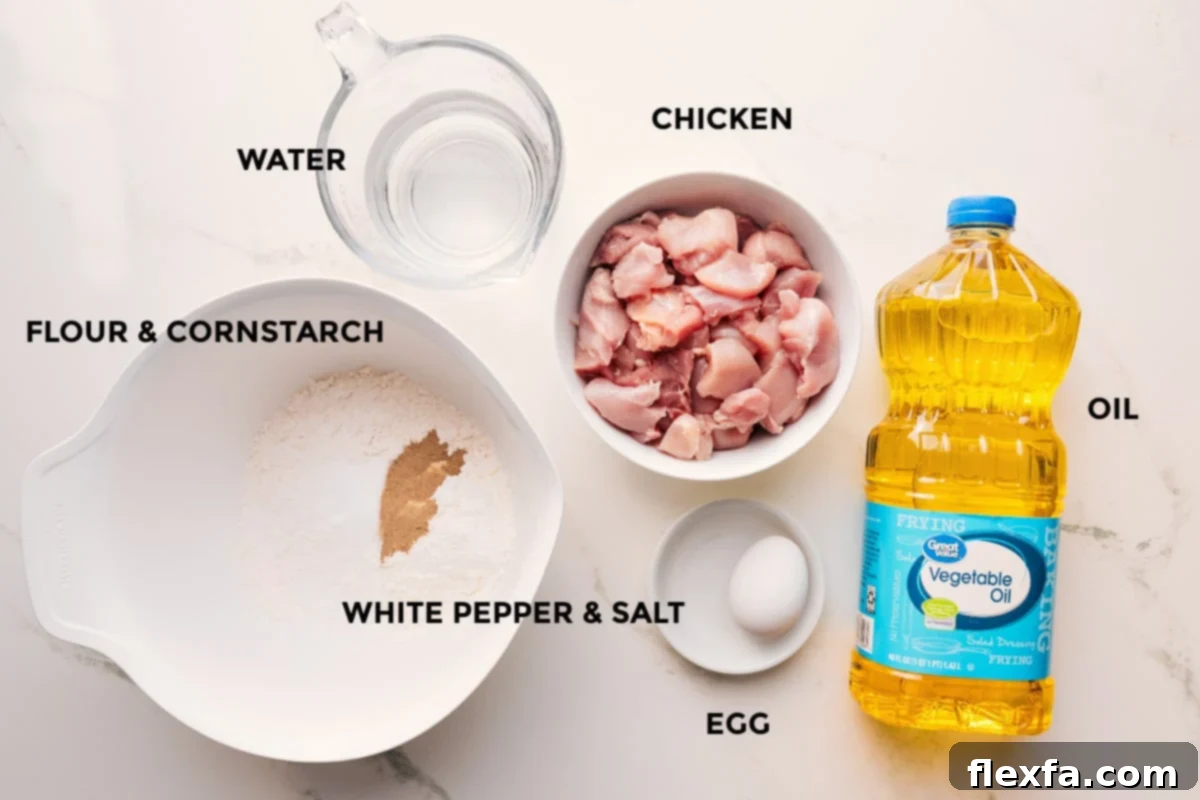 Korean Fried Chicken Delight 4 Korean chicken recipe ingredients prepped out for easy assembly including the flour, cornstarch, water, chicken, white pepper, salt, egg, and oil.