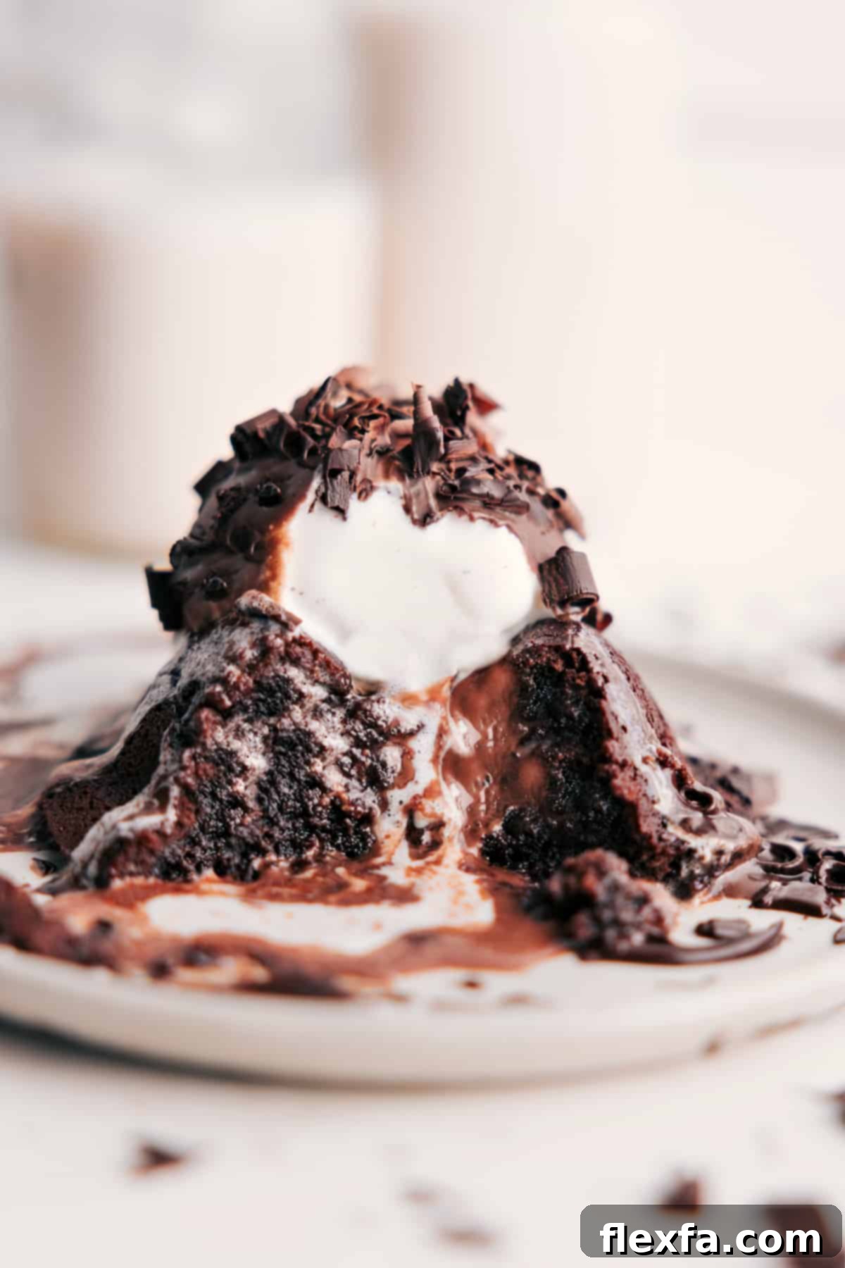 Chili's lava cake topped with vanilla ice cream and chocolate sauce, revealing the gooey chocolate center.