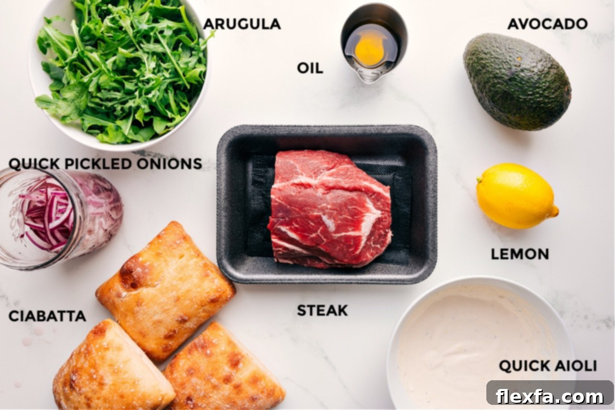 Ingredients for the steak sandwich recipe: steak, ciabatta, arugula, avocado, pickled onions, and lemon aioli.