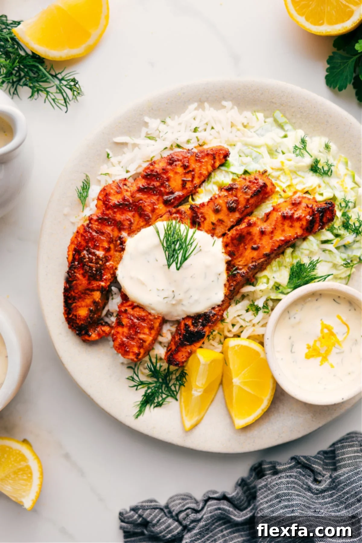 Blackened Salmon Recipe on a bed of rice topped with a lemon-dill sauce.