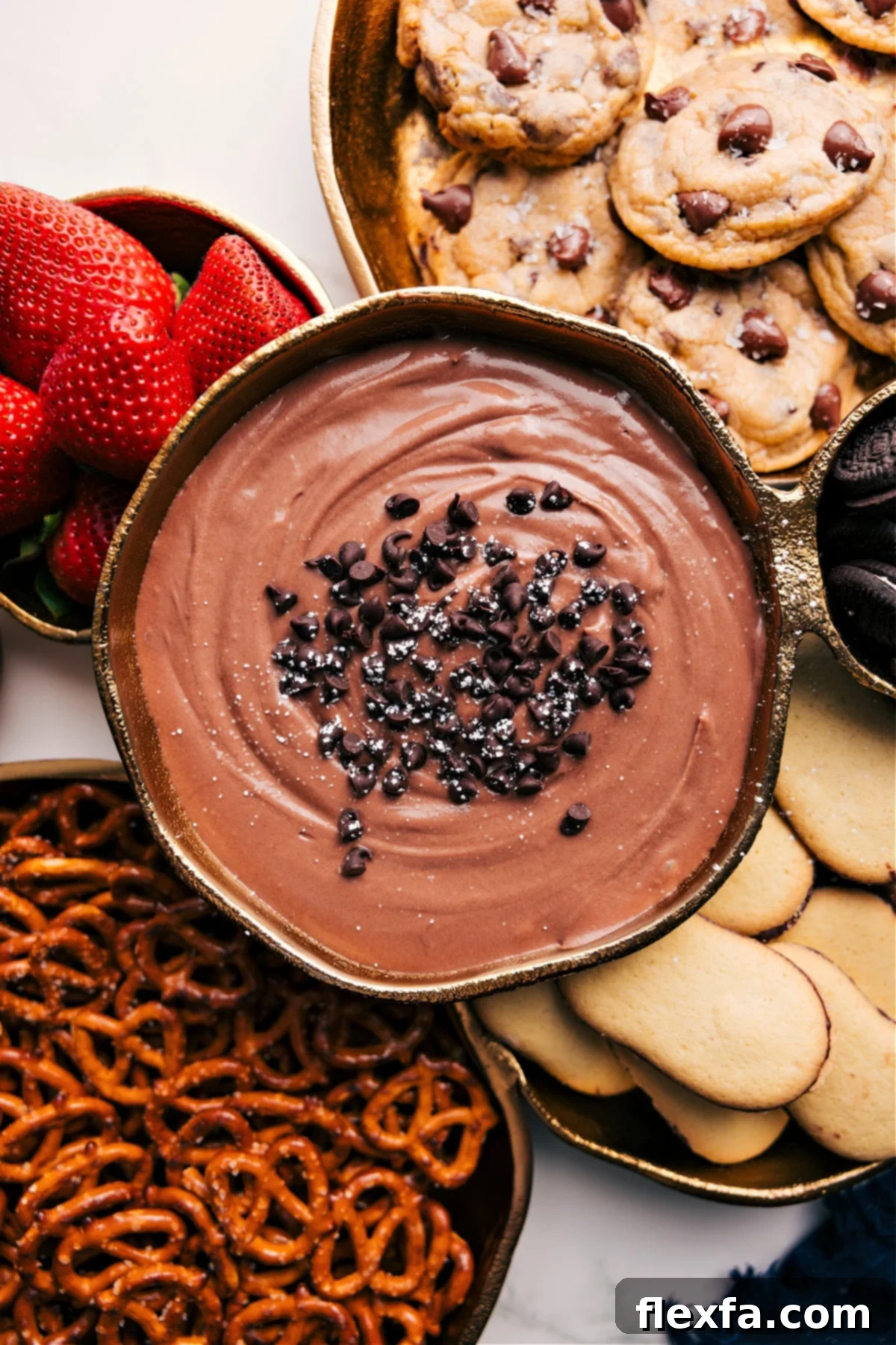 The dessert in a bowl with all the dipping options around it.