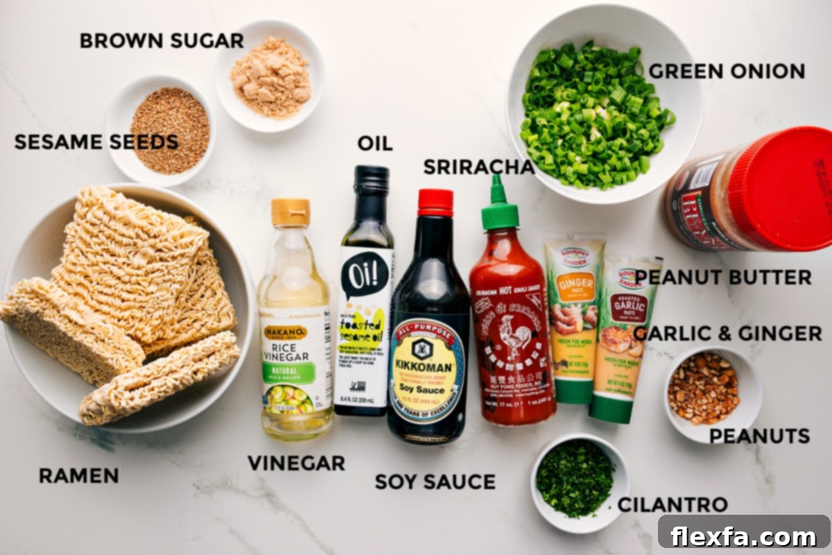 All the ingredients in this recipe prepped out for easy assembly including the ramen, sesame seeds, brown sugar, vinegar, oil, soy sauce, sriracha, cilantro, peanut butter, garlic, ginger, peanuts, and green onions.