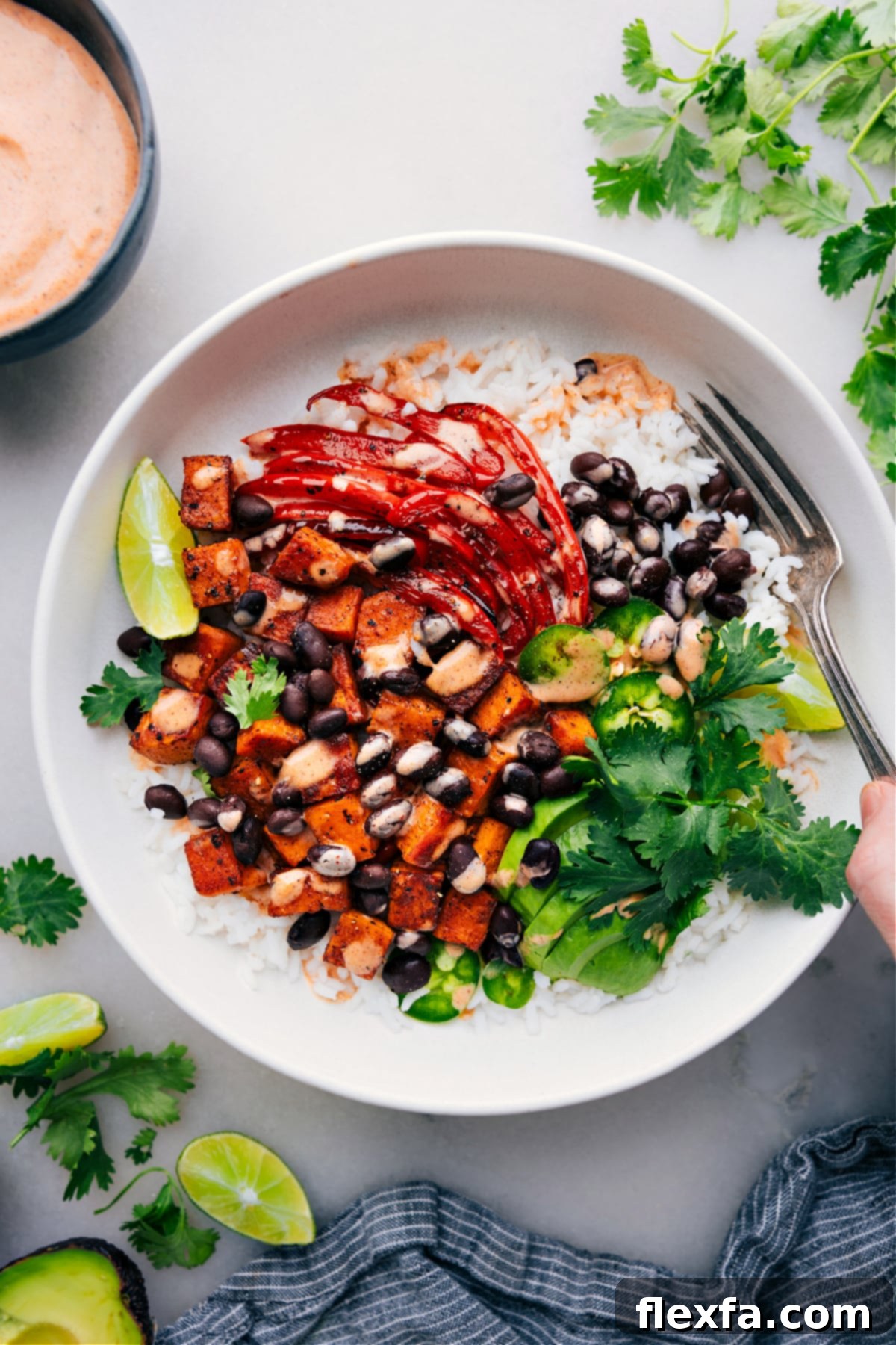 A sweet potato burrito bowl with black beans and avocado.
