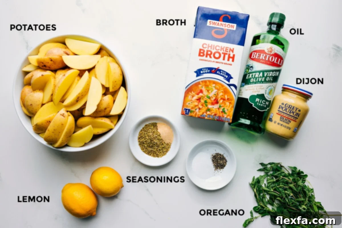 All essential ingredients for Greek Potatoes Recipe laid out: Yukon gold potatoes, fresh lemons, chicken broth, olive oil, dried oregano, garlic powder, salt, pepper, and Dijon mustard.
