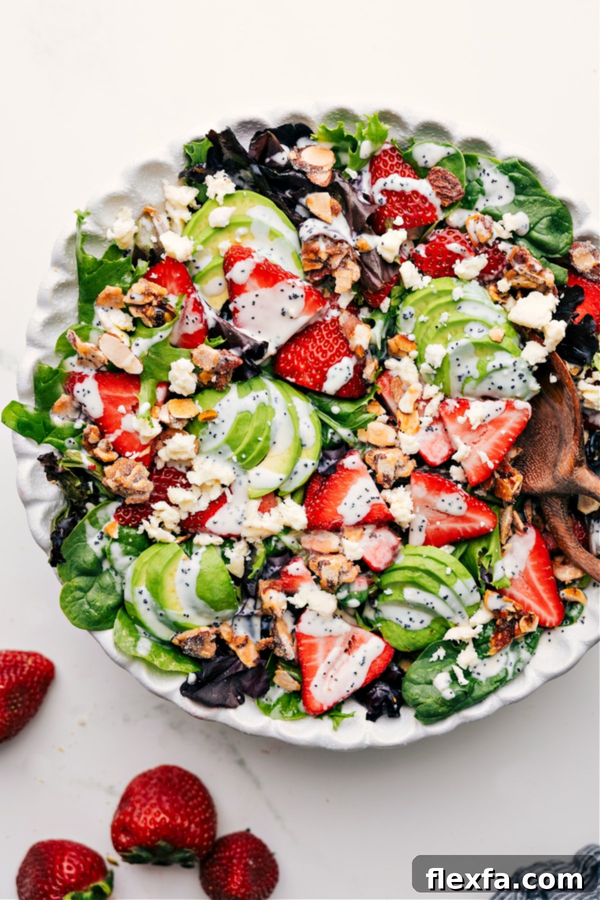 Vibrant Strawberry Poppyseed Salad with avocado and almonds.