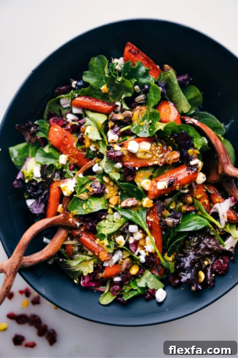 A large bowl of Roasted Carrot Salad with goat cheese and pistachios.