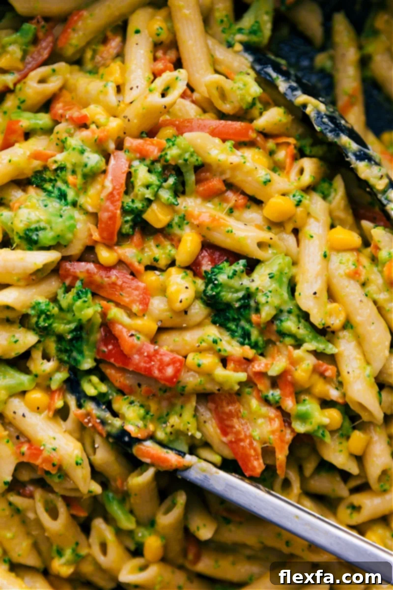 A large bowl of colorful Vegetable Pasta, tossed in a light and creamy sauce without heavy cream, featuring a medley of fresh veggies.