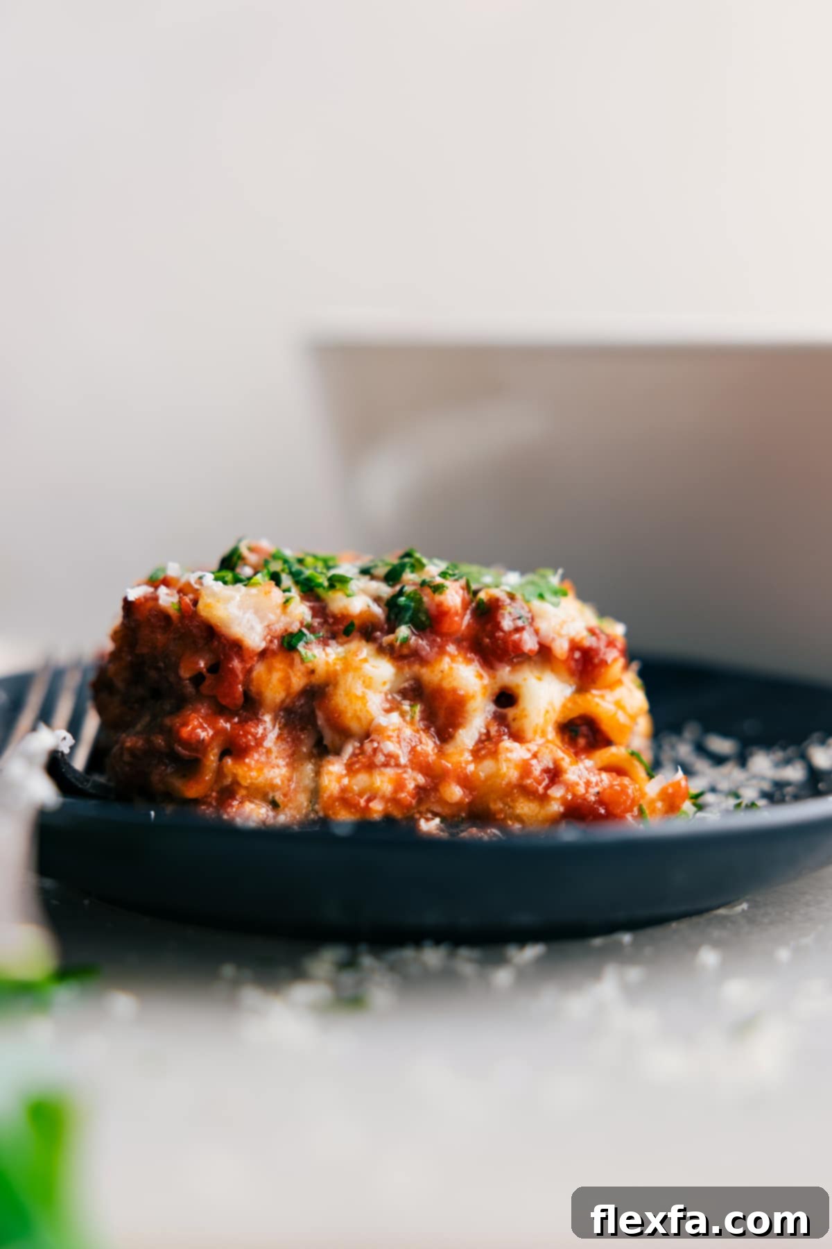 A classic, layered Lasagna casserole, showing rich tomato sauce, sweet Italian sausage, ground beef, tender pasta, and a melted cheese blend.