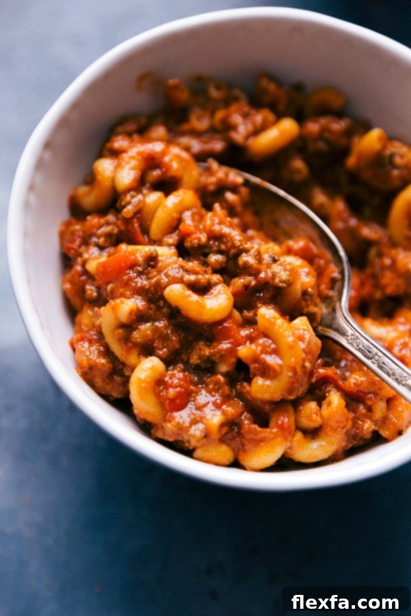 A hearty bowl of American Goulash with ground beef, elbow macaroni, and bell peppers in a rich tomato sauce, ready to serve.