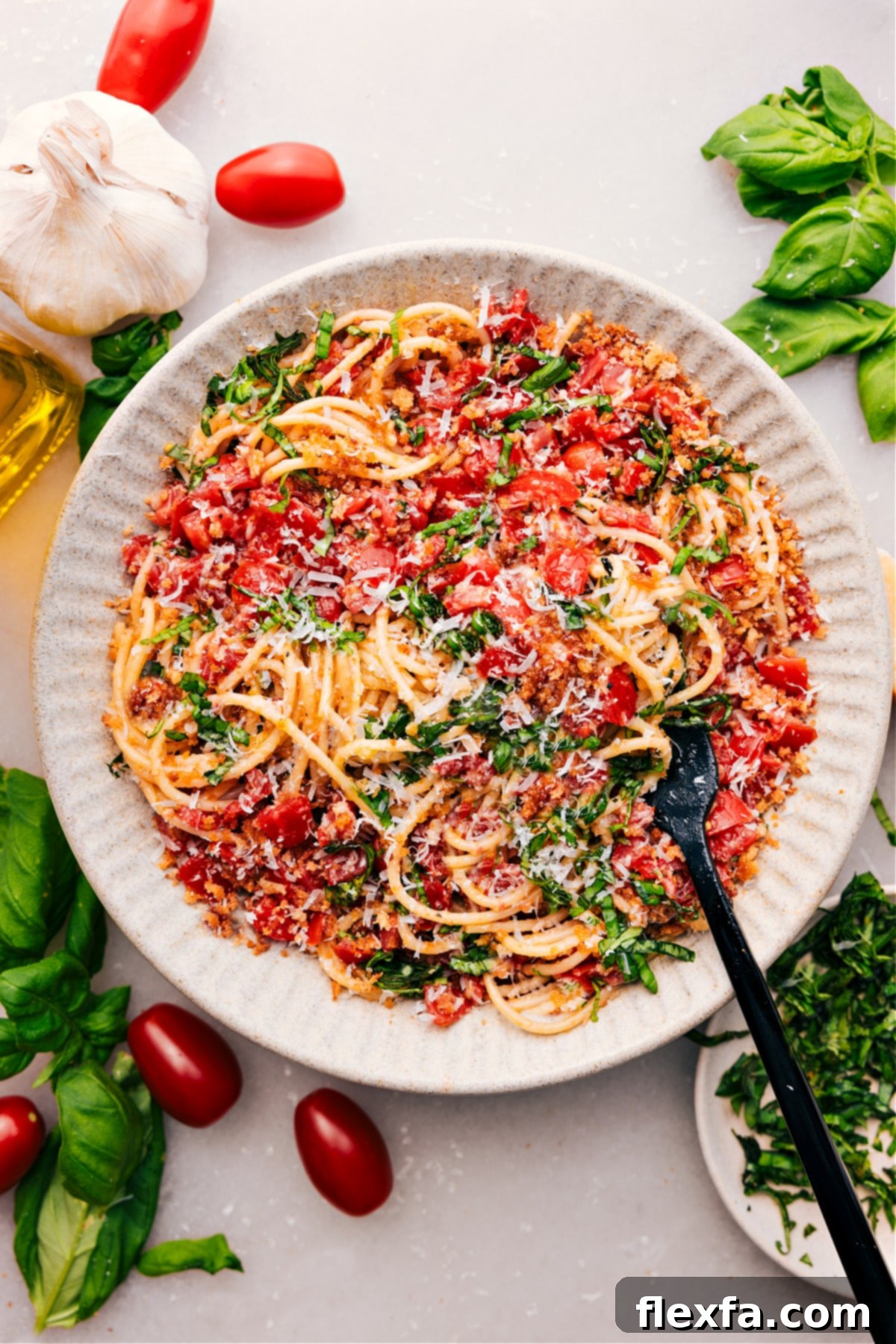 Fresh Bruschetta Pasta in a bowl, featuring diced tomatoes, basil, garlic, and Parmesan cheese mixed with al dente pasta.
