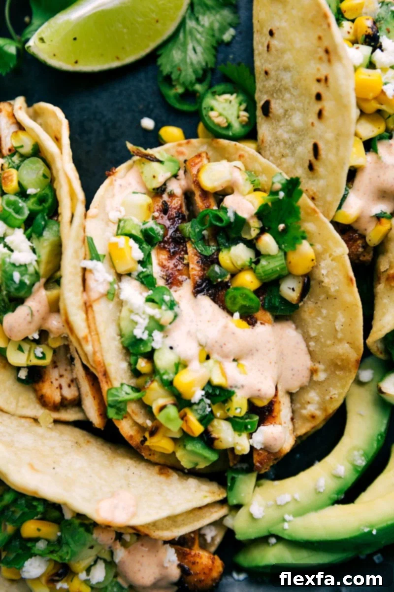 Mexican street corn chicken tacos with smoky corn, fresh herbs, and a creamy chili-lime dressing.