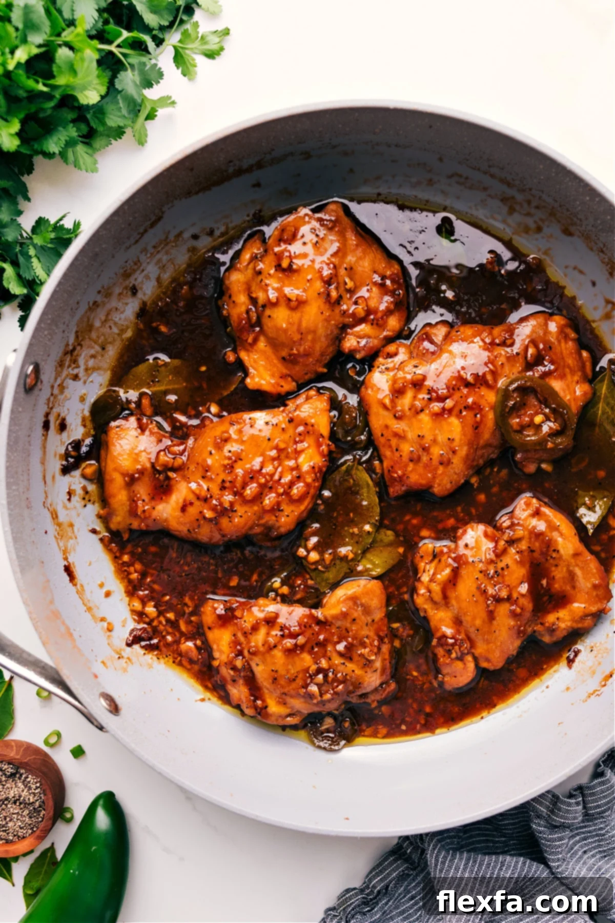 Rich and savory Chicken Adobo, a Filipino classic, featuring tender chicken cooked in a flavorful sauce.