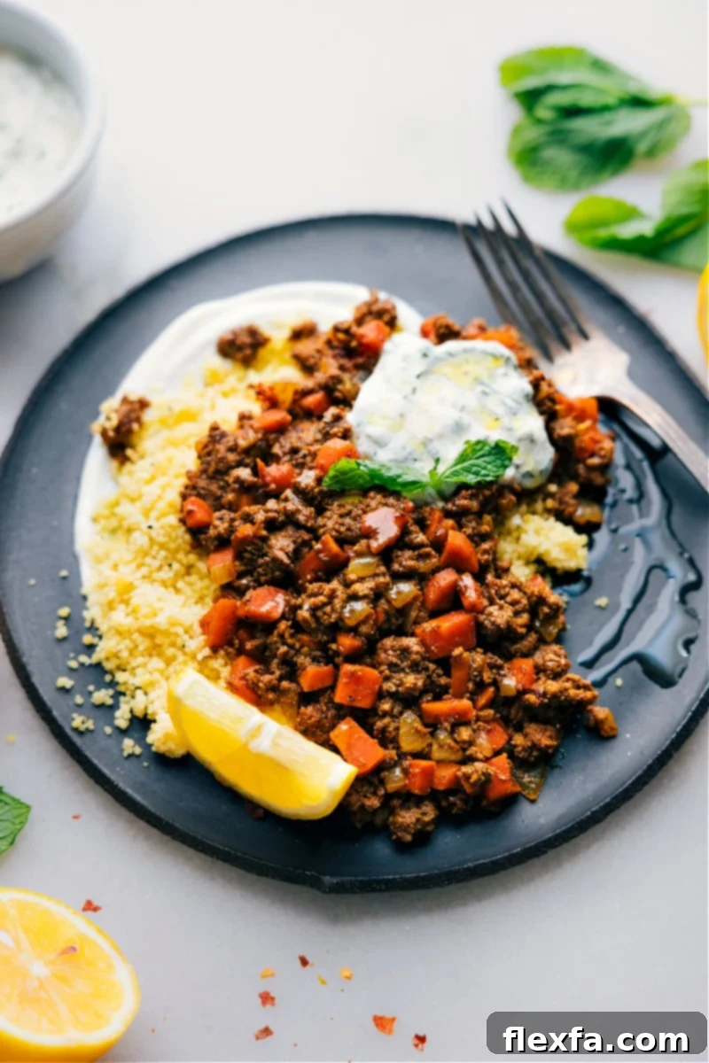 Middle Eastern Ground Beef Bowls topped with a refreshing mint yogurt sauce, carrots, and sweet onions.