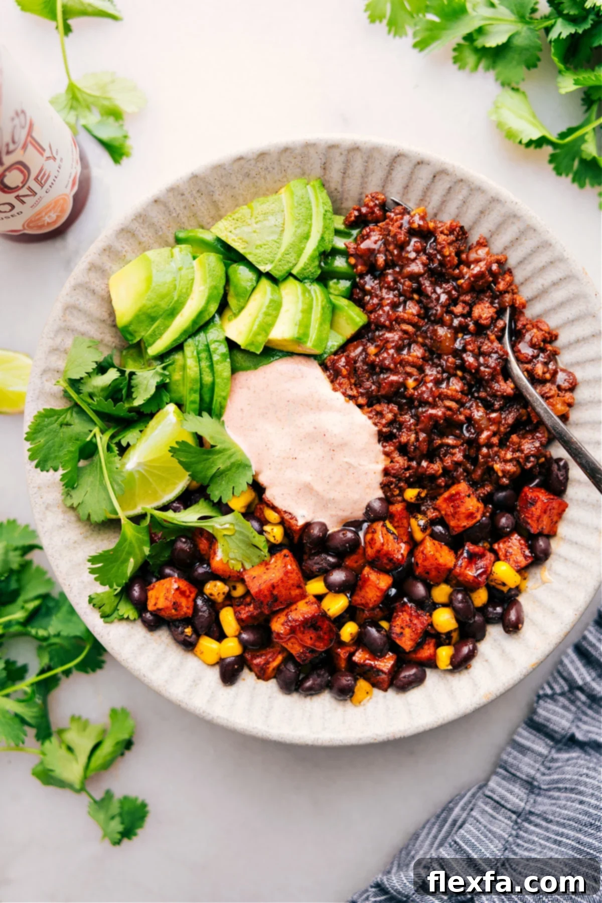 Healthy ground beef recipes: A vibrant ground beef taco bowl, generously topped with a flavorful sauce and fresh ingredients.