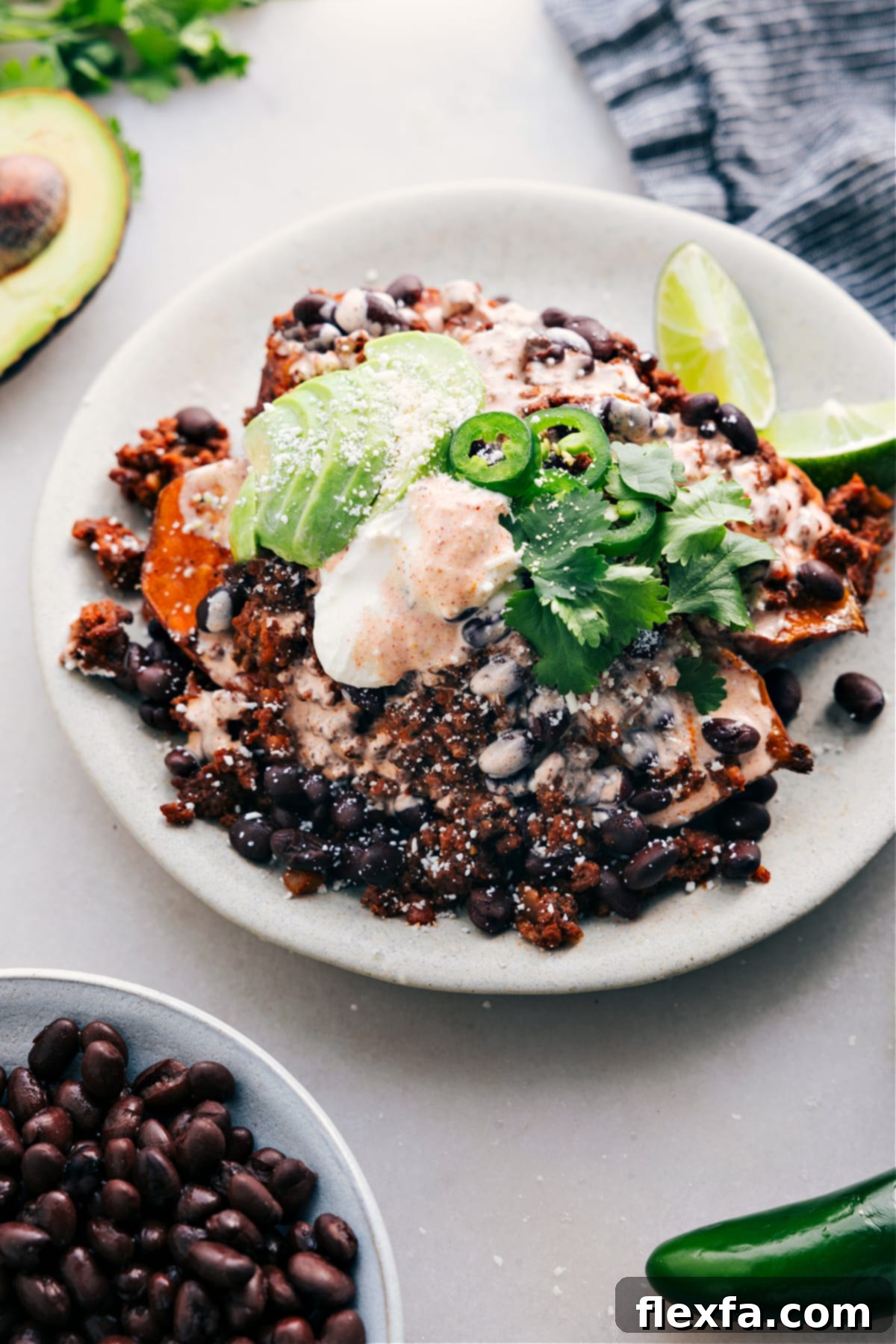Hearty Taco Stuffed Sweet Potatoes, generously piled high with all the best savory toppings.