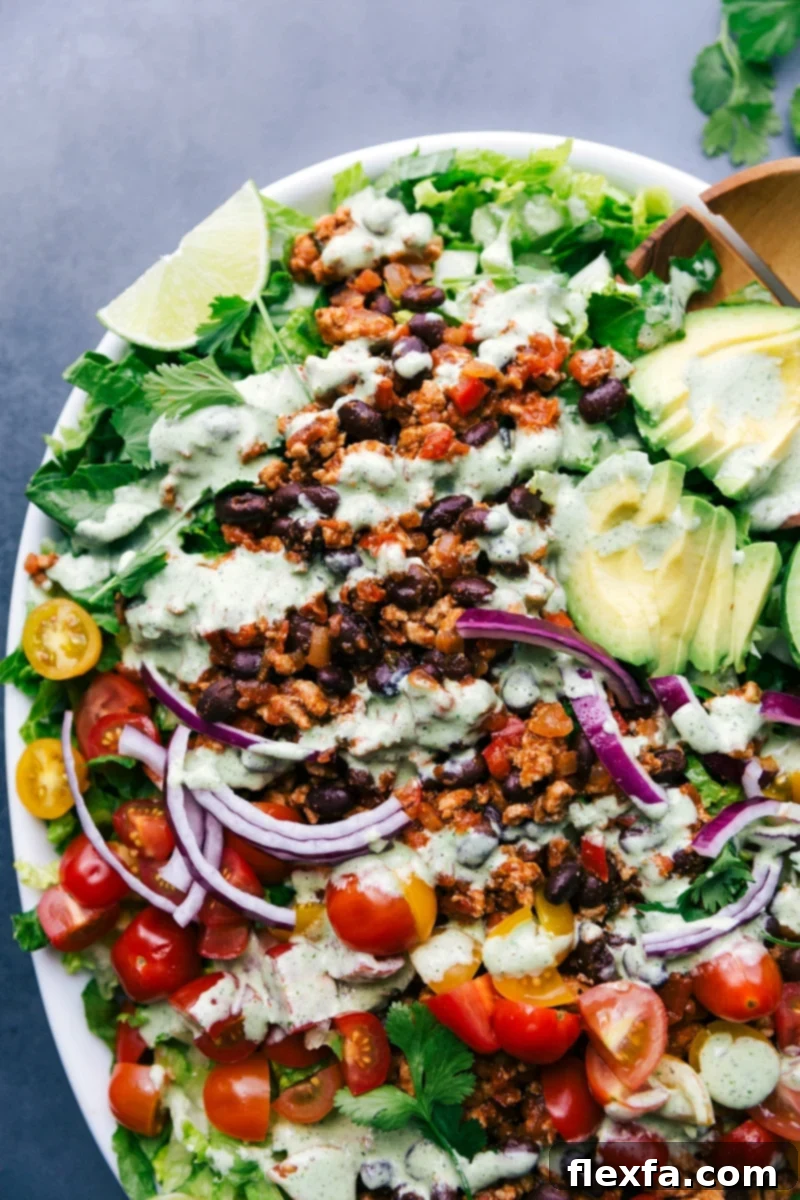 A vibrant, colorful, and fully dressed turkey taco salad, ready to be served and enjoyed.
