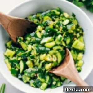 A close-up shot of the refreshing Smashed Cucumber Salad, showcasing its vibrant colors and inviting texture.