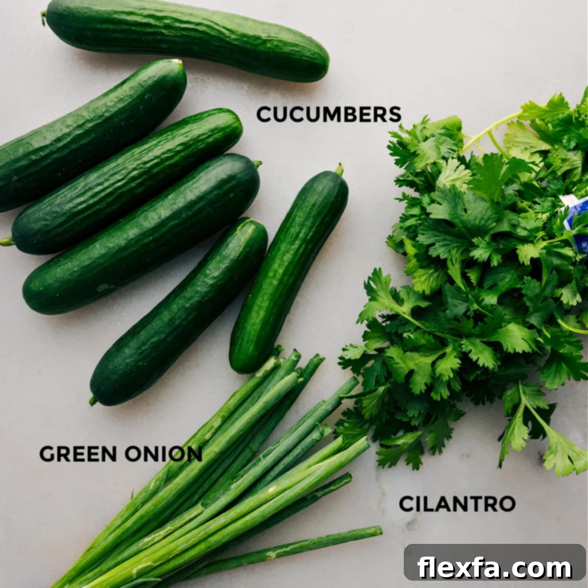 The three main fresh ingredients – crisp cucumbers, vibrant green onions, and fresh cilantro – perfectly prepped and ready for assembly into a delicious Smashed Cucumber Salad.