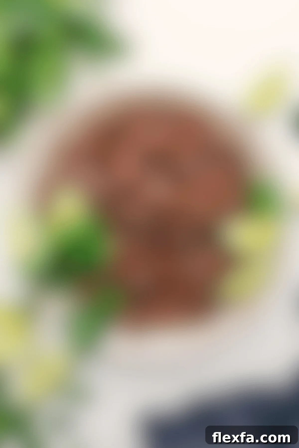 Flavorful Chipotle beef barbacoa served in a rustic bowl, garnished with fresh cilantro and vibrant lime wedges on the side.
