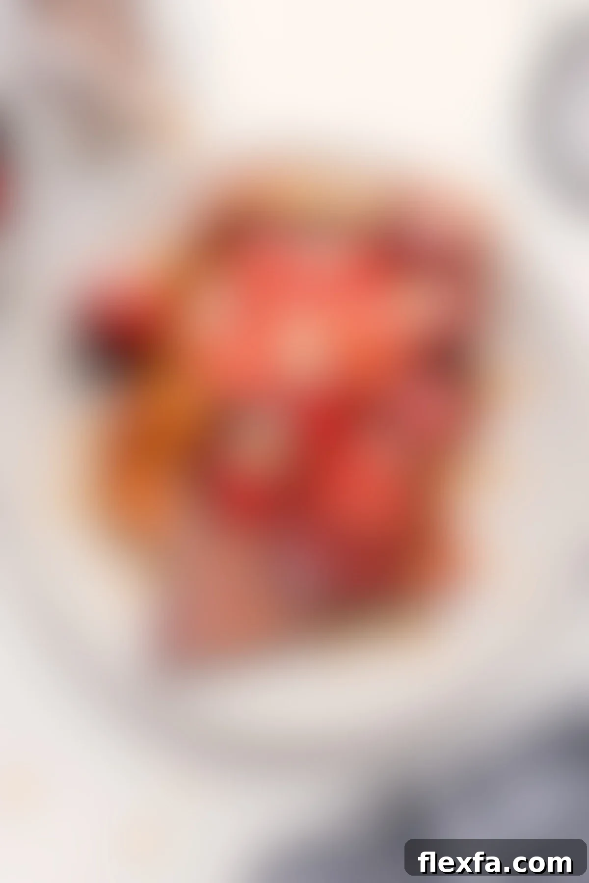 A delightful plate of Kneader's French toast copycat recipe, generously topped with fresh strawberries and drizzled with sweet syrup.