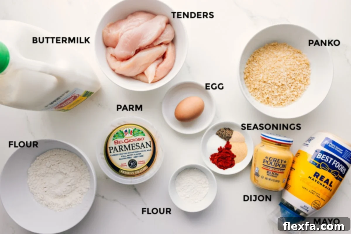 All the ingredients for Parmesan Chicken Tenders laid out: chicken, buttermilk, panko, Parmesan, flour, mayo, egg, Dijon, garlic powder, and paprika.