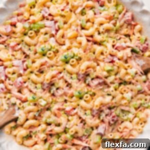A close-up shot of the finished creamy macaroni salad, garnished and ready to serve.