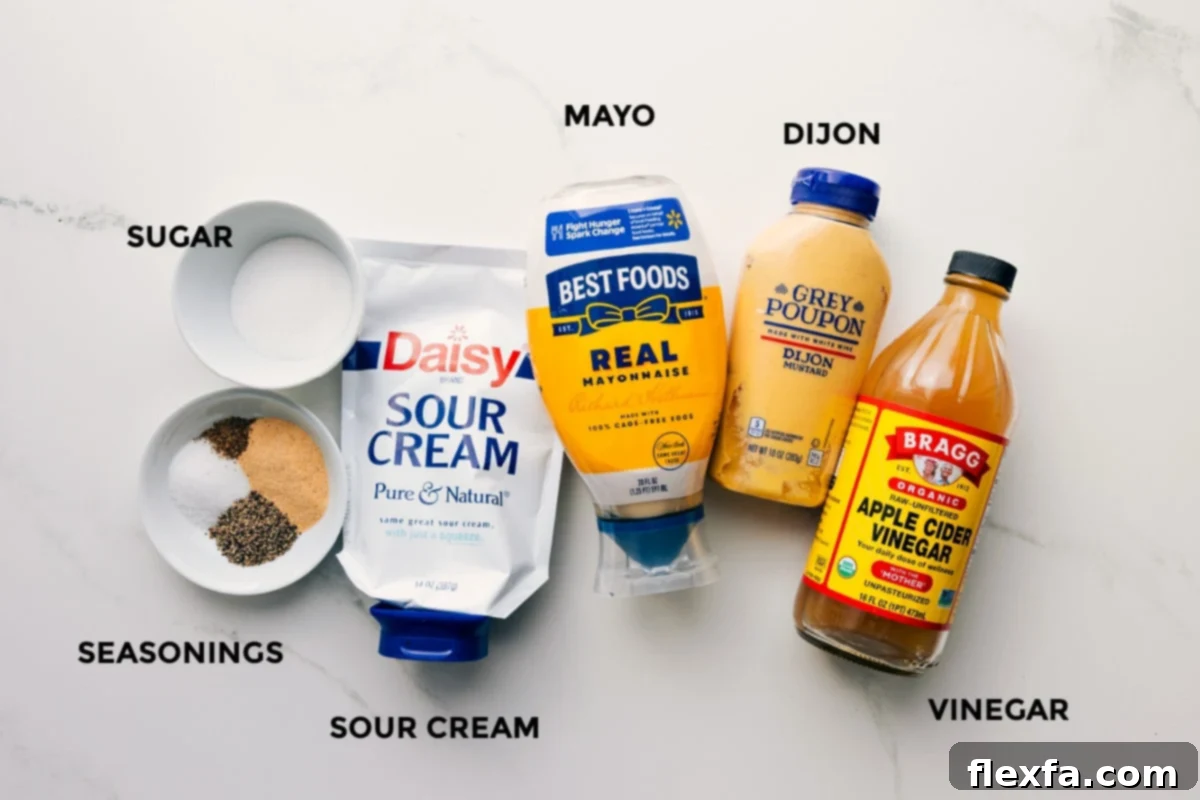 All the essential ingredients for the creamy and tangy dressing of this macaroni salad, including mayonnaise, sour cream, Dijon mustard, apple cider vinegar, sugar, and spices, laid out for easy assembly.