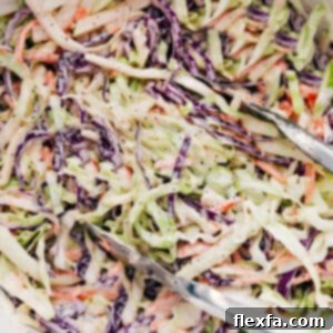 A beautifully presented bowl of freshly made Easy Coleslaw, showcasing its creamy dressing and vibrant vegetables, ready to be served.
