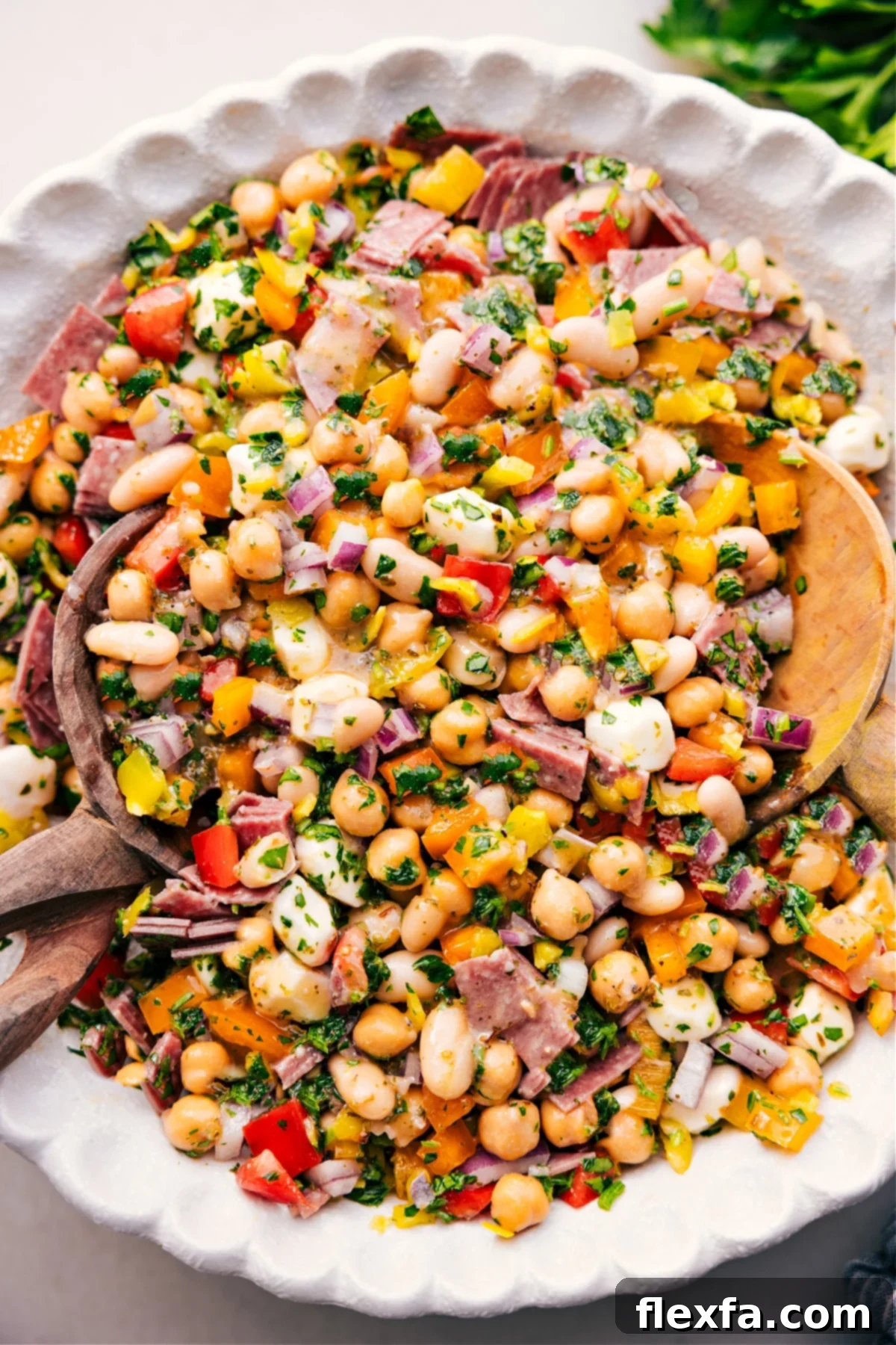 A hearty dense bean salad, generously dressed and tossed, presented in a large bowl, ready for serving.