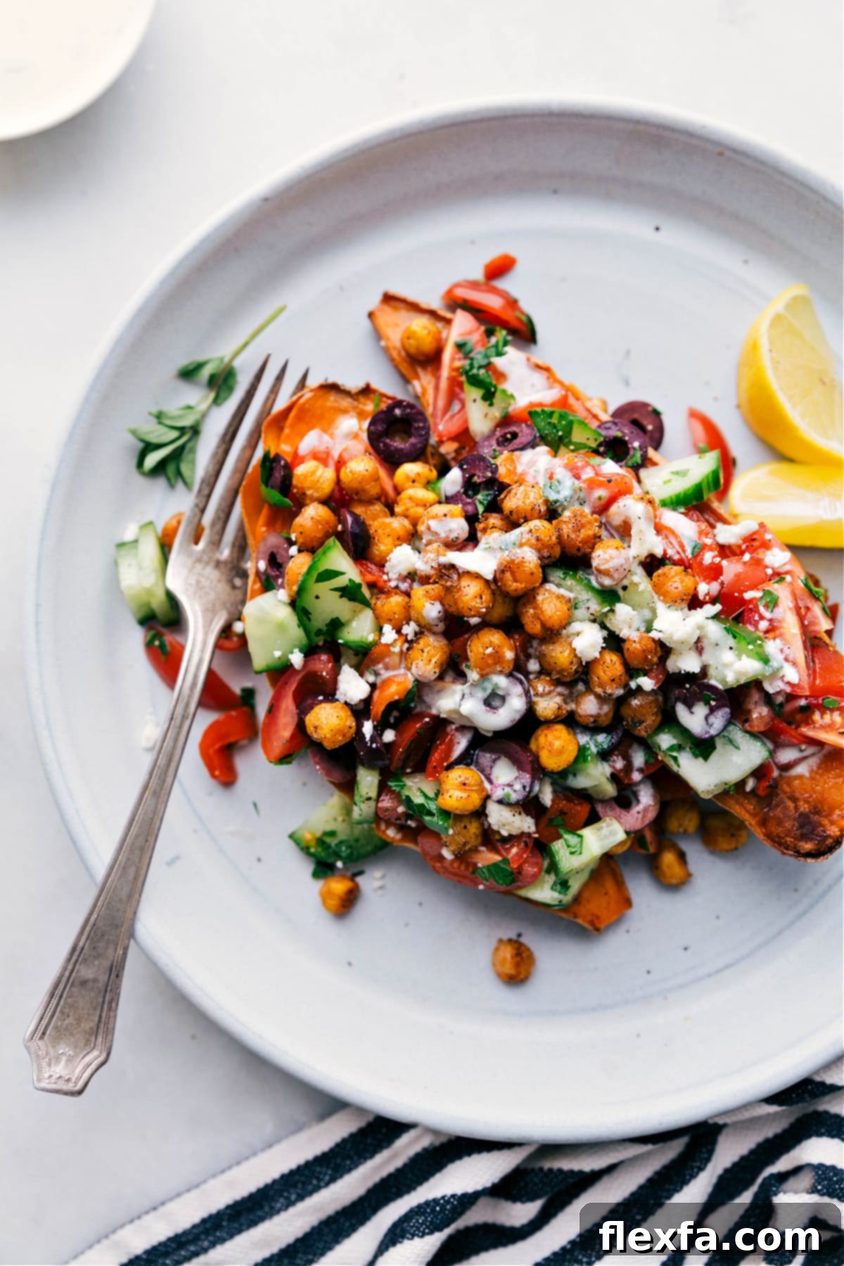 Mediterranean sweet potatoes topped with crispy chickpeas, fresh herbs, and a flavorful dressing.