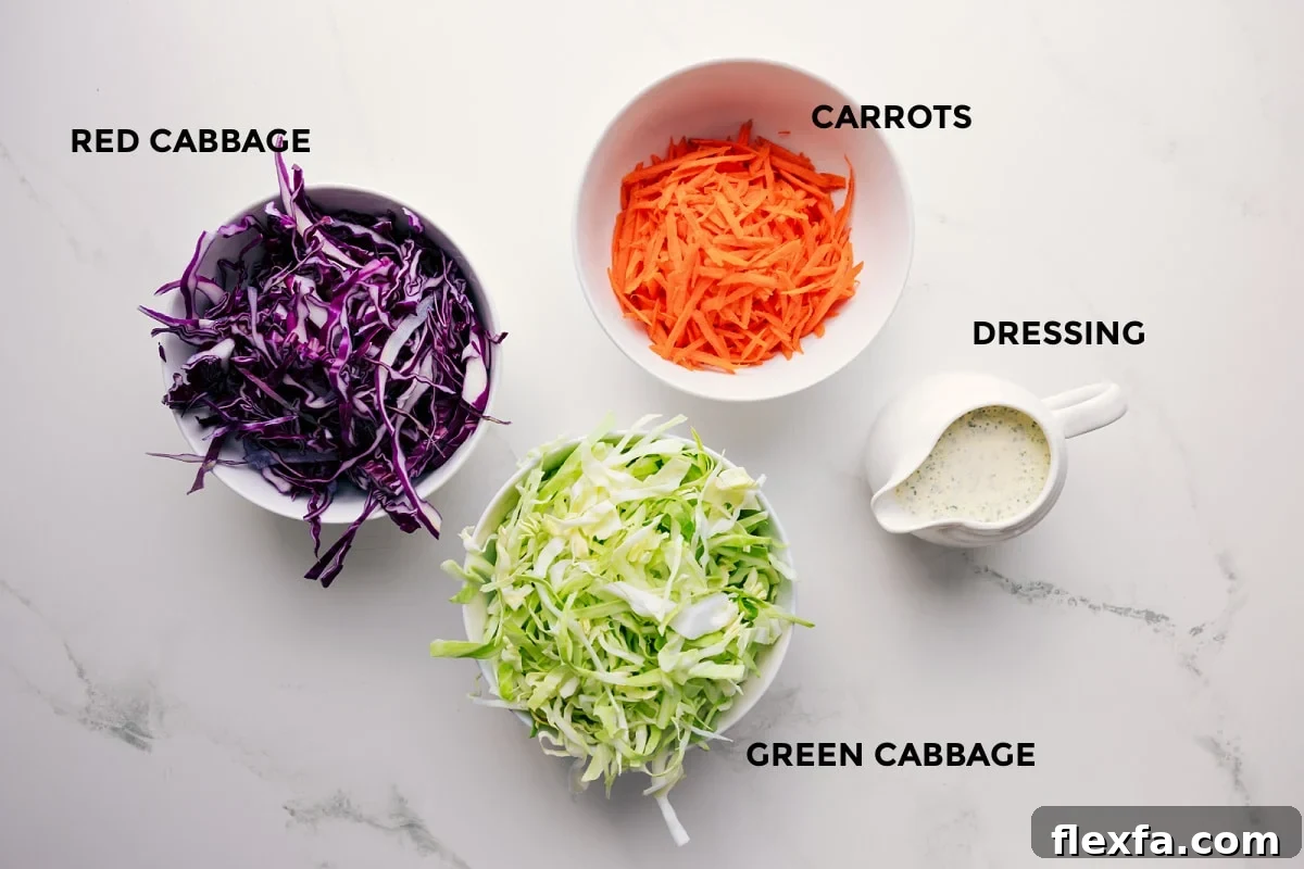 All the ingredients in this recipe prepped out for easy assembly including the red cabbage, green cabbage, dressing, and carrots.