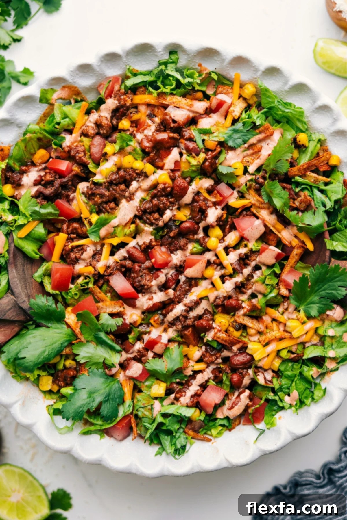 A large bowl of the ultimate Taco Salad, fully dressed and ready to be served, showcasing the vibrant colors of the ingredients.
