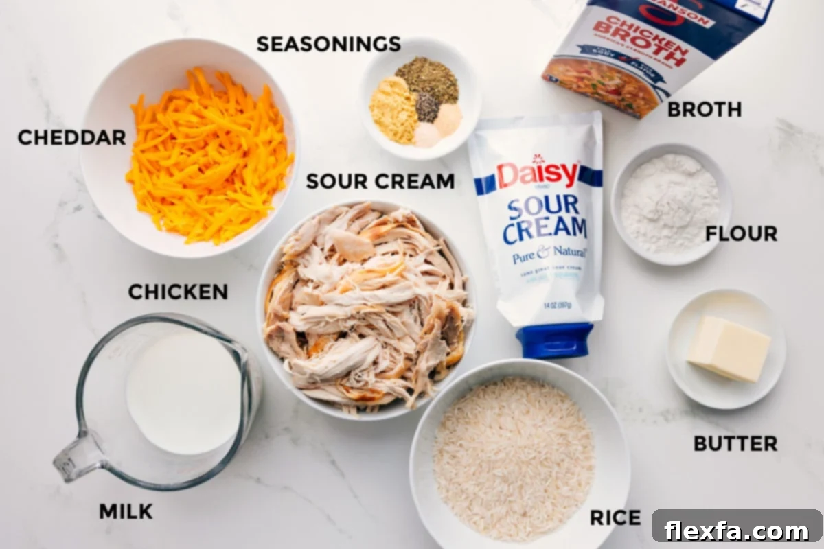 Ingredients for Hawaiian Haystacks, including milk, chicken, cheese, spices, sour cream, and flour, arranged neatly on a countertop.