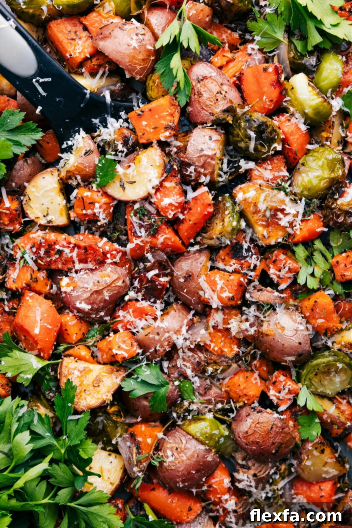 A sheet pan of colorful roasted vegetables with caramelized edges.