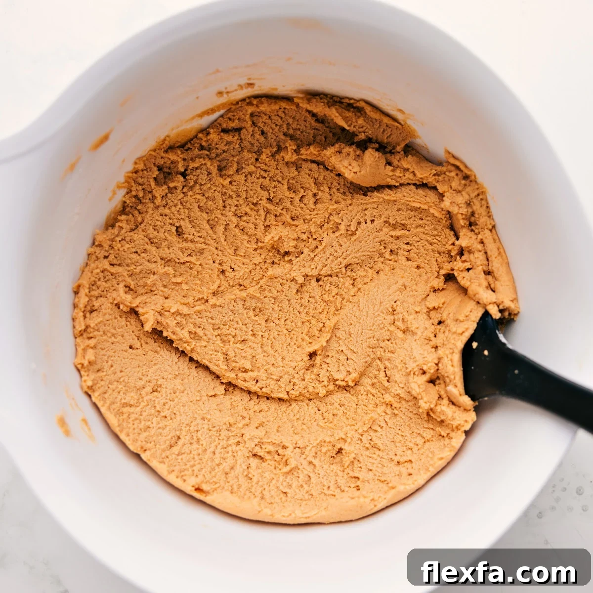 The safe to eat dough in a bowl ready to be enjoyed.