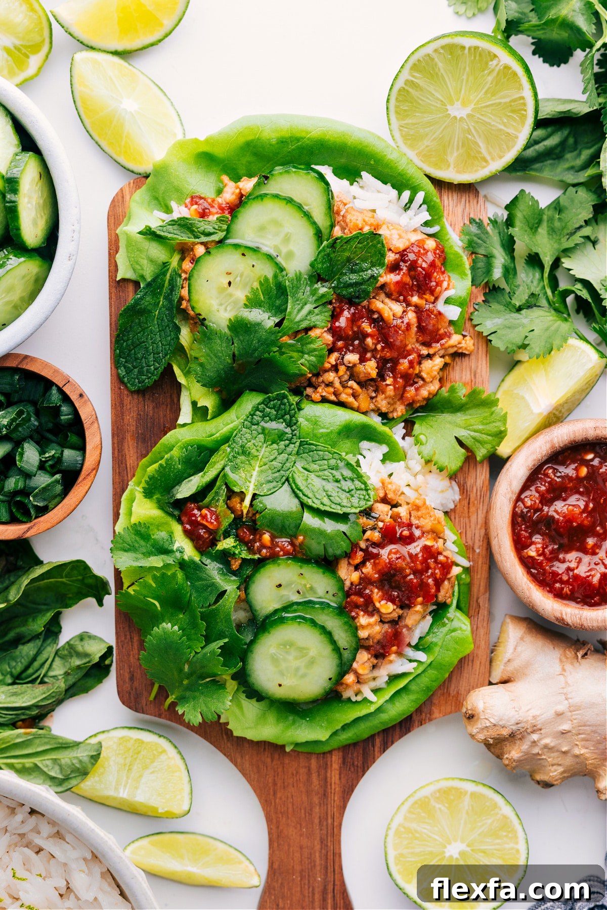 Asian Chicken Recipes: Chicken larb served in lettuce wraps with cucumbers and parsley on top.