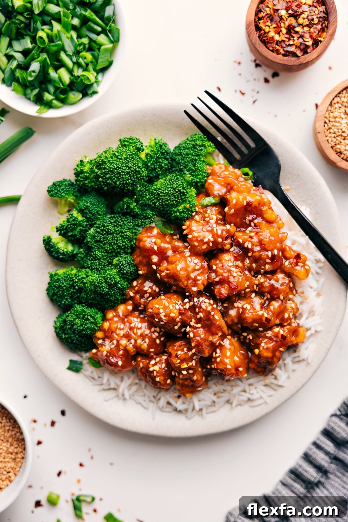 Panda express orange chicken over rice with broccoli on the side.