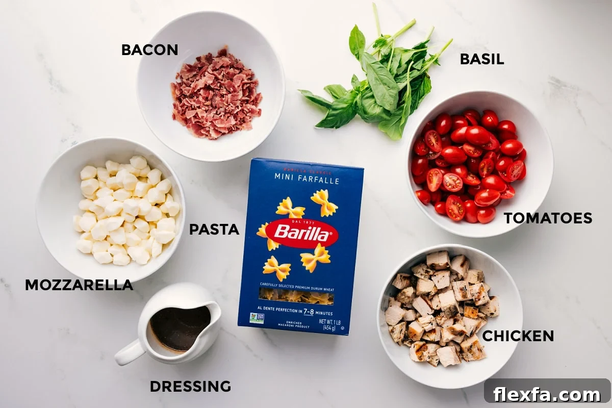 Ingredients In Caprese Pasta Salad All the ingredients in this recipe prepped out for easy assembly including the bacon, mozzarella, dressing, pasta, chicken, tomatoes, and basil.