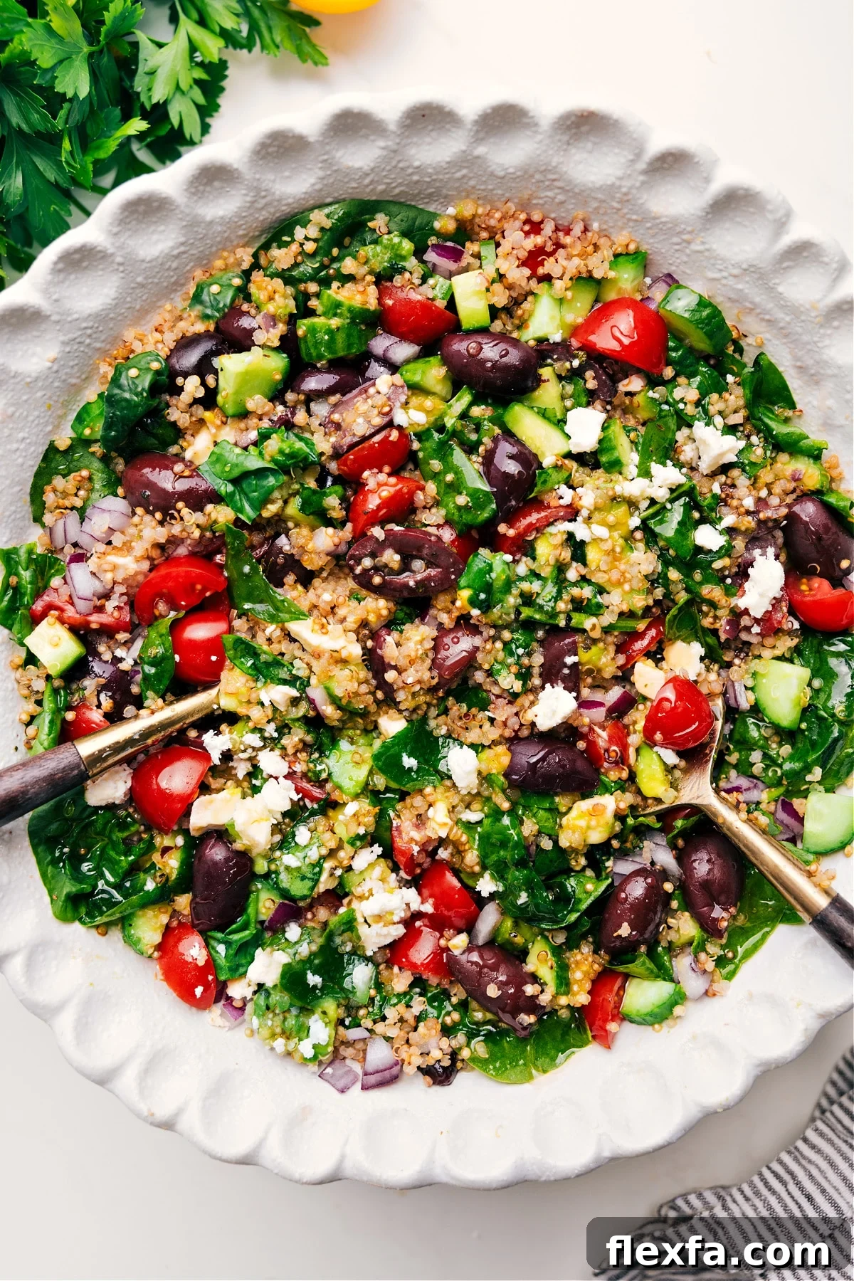 A big quinoa salad in a bowl tossed together and dressed.